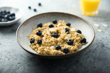 Wall Mural - Homemade oatmeal porridge with blueberry and almond flakes