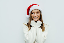 Portrait Of A Smiling Beautiful Woman In Christmas Santa Hat Isolated On White Background.