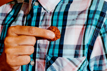Man Putting A Veggie Meatball In His Pocket