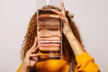 Crop woman with glass of water