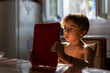 © Nasos Zovoilis/Stocksy - Boy looking a digital tablet