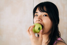 Woman Eating Apple At Home