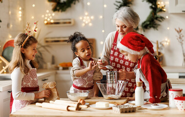 Poster - Multiethnic family, grandmother and three little kids, cooking Christmas cookies together in kitchen