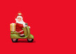 © Westend61 - Christmas ornament of Santa Claus riding motor scooter against vibrant red background