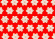© Westend61 - Pattern of snowflake shaped Christmas cookies flat laid against vibrant red background