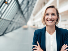 Blond Businesswoman Smiling In Office