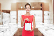 © Syda Productions - sale, luxury and people concept - smiling elegant woman in red dress with small shopping bag over jewelry store background
