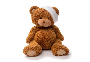 Wall Mural - medicine, healthcare and childhood concept - teddy bear toy with bandaged head on white background