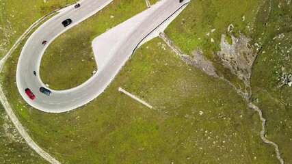 Canvas Print - Windy and steep mountain road with car traffic in summer season