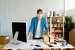 © Westend61 - Young businessman leaning on desk in office
