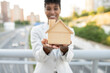 © Westend61 - Female real estate agent holding wooden model home