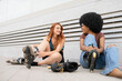 © Westend61 - Happy female friends wearing inline skates on footpath