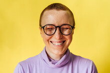 Happy Woman With Eyes Closed Against Yellow Background