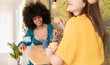 © Westend61 - Multi-ethnic female friends having biscuits with coffee at home