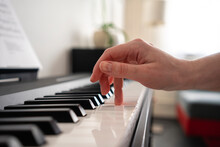 Mid Adult Woman Playing Piano At Home