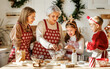© JenkoAtaman - Happy family with children cooking together on Christmas day in cozy home kitchen