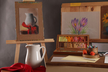 Canvas Print - Artist's workplace with drawings, soft pastels and color pencils on table