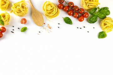 Wall Mural - Ingredients for cooking Italian pasta on a white plate with place for text. Spaghetti, cherry tomatoes, basil, wooden spoon. Flat lay cooking