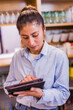 © Sangiao_Photography - small business woman owner using tablet technology. young Peruvian Latinx bistro entrepreneur