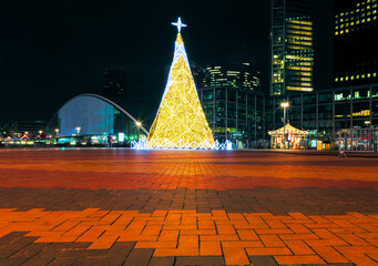 Christmas tree in modern city . Skyscrapers in the new year night