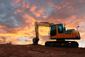 Canvas Print - Yellow  Excavators are digging the soil in the construction site on the  cloud  sky background