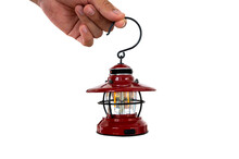 Hand Holding A Small Lantern Isolated On White Background