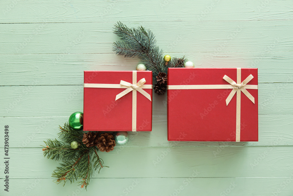 Beautiful composition with Christmas gift boxes, fir branches and decor on green wooden background