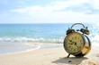 © Photo Sesaon - Morning of a new day, alarm clock  on the beach sunlight in morning. Health concept.