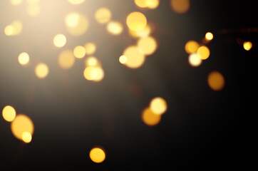 Wall Mural - defocused lights golden color on a black background