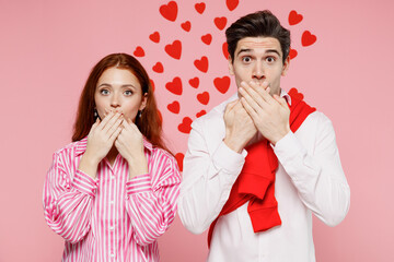 Wall Mural - Young couple two friends woman man 20s wearing casual shirt look camera cover mouth with hand isolated on plain pastel pink background studio portrait. Valentine's Day birthday holiday party concept.