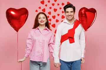 Wall Mural - Young happy fun cheerful couple two friends woman man wear shirt hold red bunch of inflatable balloons isolated on plain pink background studio portrait Valentine's Day birthday holiday party concept