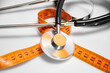 © Leila - Tape measure and stethoscope or phonendoscope on a white background: a nutritionist concept for a healthy lifestyle, problems of excess weight and cardiovascular diseases