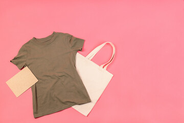 Wall Mural - Blank t-shirt, bag and carton sheet on pink background