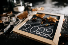 Baking Christmas Gingerbread Cookies On A Dark Wooden Table. Preparing For Baking. Winter Holidays. 2022 New Year Sign. Top View. 