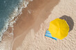 Yellow beach umbrella and sunbed on sandy coast near sea, aerial view. Space for text