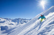 © Westend61 - Sun shining over woman skiing in Arlberg massif