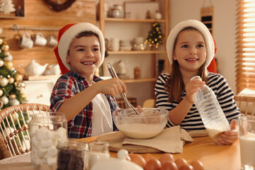 Wall Mural - Cute little children making dough for Christmas cookies at home