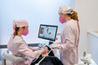 © Westend61 - Female dentist wearing protective face masks doing surgery of patient's teeth in clinic