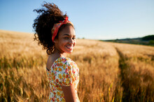 Happy Beautiful Woman With Curly Hair In Wheat Field