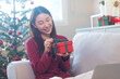 © bennnn - Christmas Gift in hands. Happy woman giving Christmas and New Year Gift box to man at Home. Family X'mas celebration. Person Holding, Receiving a Gift box.