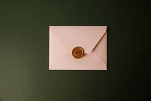 Beige Envelope On A Green Background. Congratulatory Envelope, Invitation.