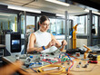 © Westend61 - Female engineer working with electrical component in industry