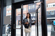 © Johnér - Smiling woman entering office