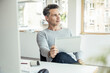 © Westend61 - Thoughtful businessman with digital tablet sitting at desk
