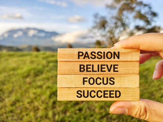 Wall Mural - Inspirational and Motivational Concept - PASSION BELIEVE FOCUS SUCCEED text background. Stock photo.