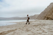 © Westend61 - Man walking near sea on beach at Point Reyes in California, USA