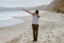 Young Man Dabbing While Standing At Beach At Point Reyes, California, USA