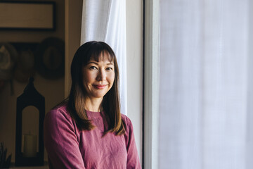 Wall Mural - Smiling Woman By Window At Home