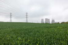 UK, England, Rugeley, Field With Electricity Pylons And Cooling Towers In Background