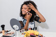 © Westend61 - Smiling female make-up artist applying blusher in studio